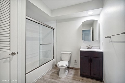 a bathroom with a toilet and a sink and a shower