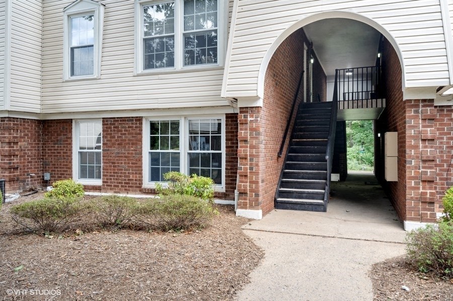 a brick and with a walkway and a staircase