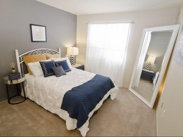 a bedroom with a bed and a mirror