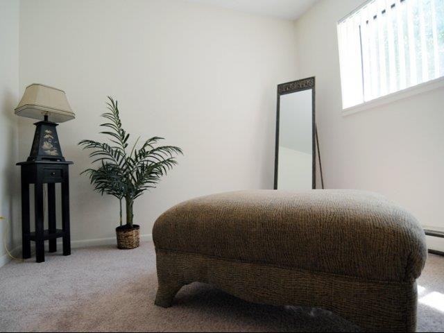 a bedroom with a bed and a mirror