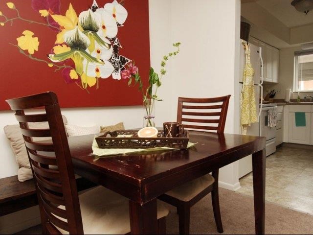 a dining room table with chairs and a cake on it