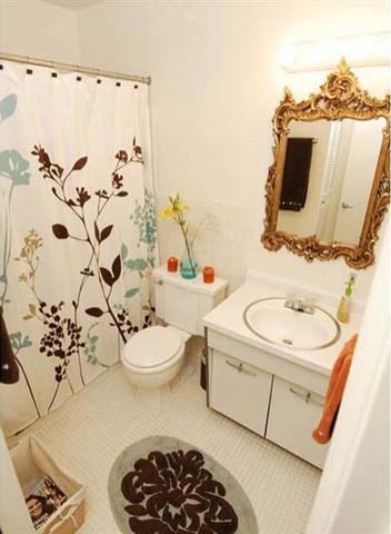 a bathroom with a shower curtain and a sink and a toilet