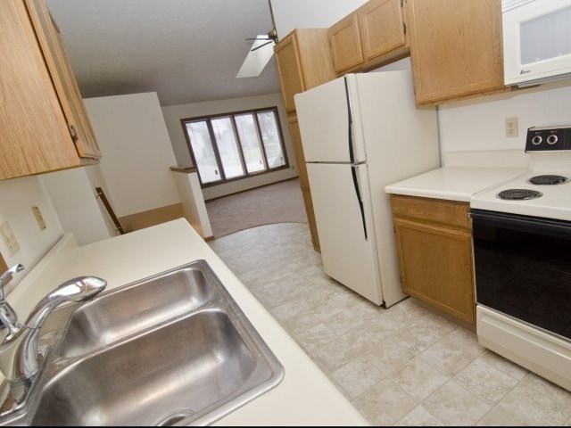 a kitchen with a sink and a refrigerator