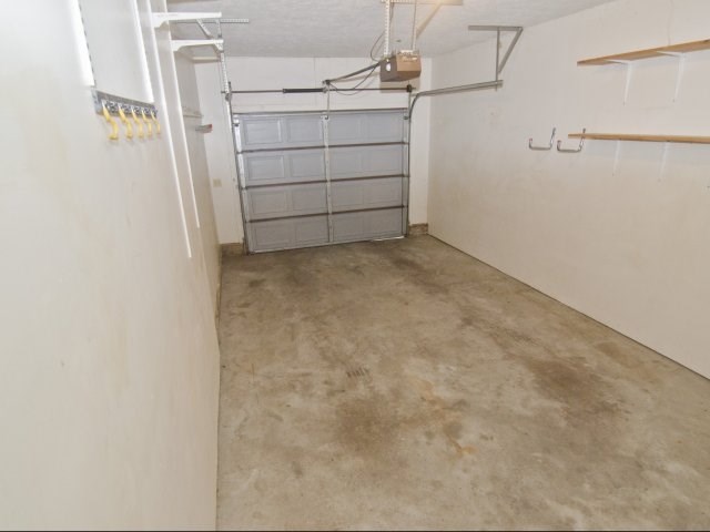 a room with a cement floor and white walls