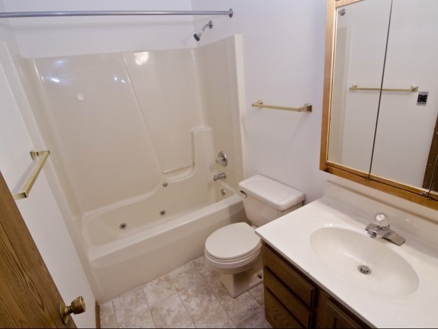 a bathroom with a sink toilet and a tub