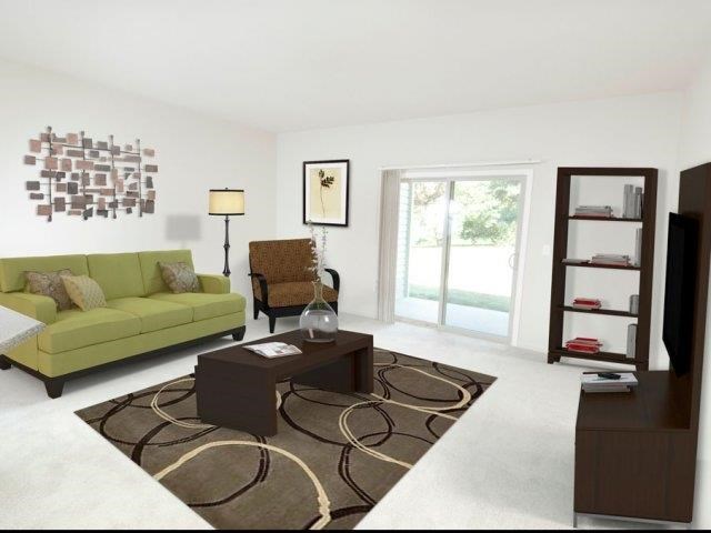 a living room with a green couch and a coffee table