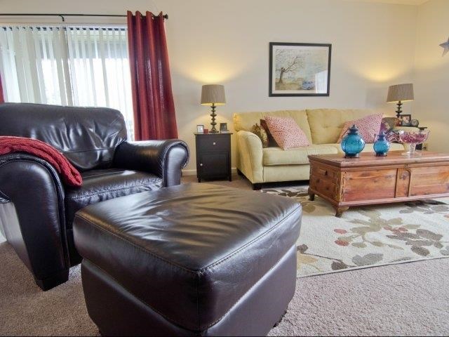 a living room with a leather chair and a couch