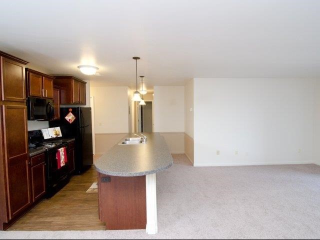 an empty kitchen with an island in the middle