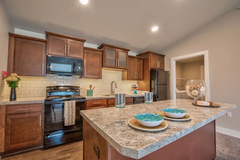 a kitchen with wooden cabinets and granite counter tops