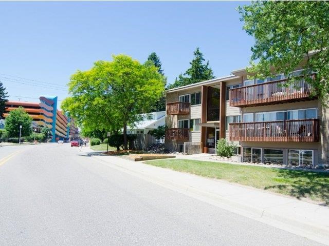 an empty street in front of some apartment buildings