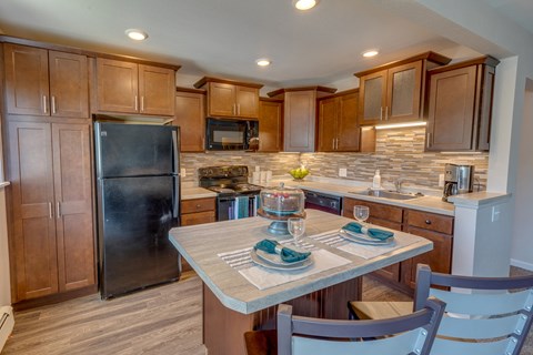 a kitchen with stainless steel appliances and wooden cabinets