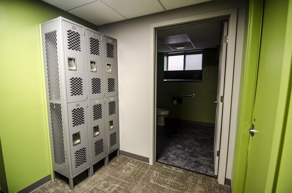 a room with some lockers and a toilet in it