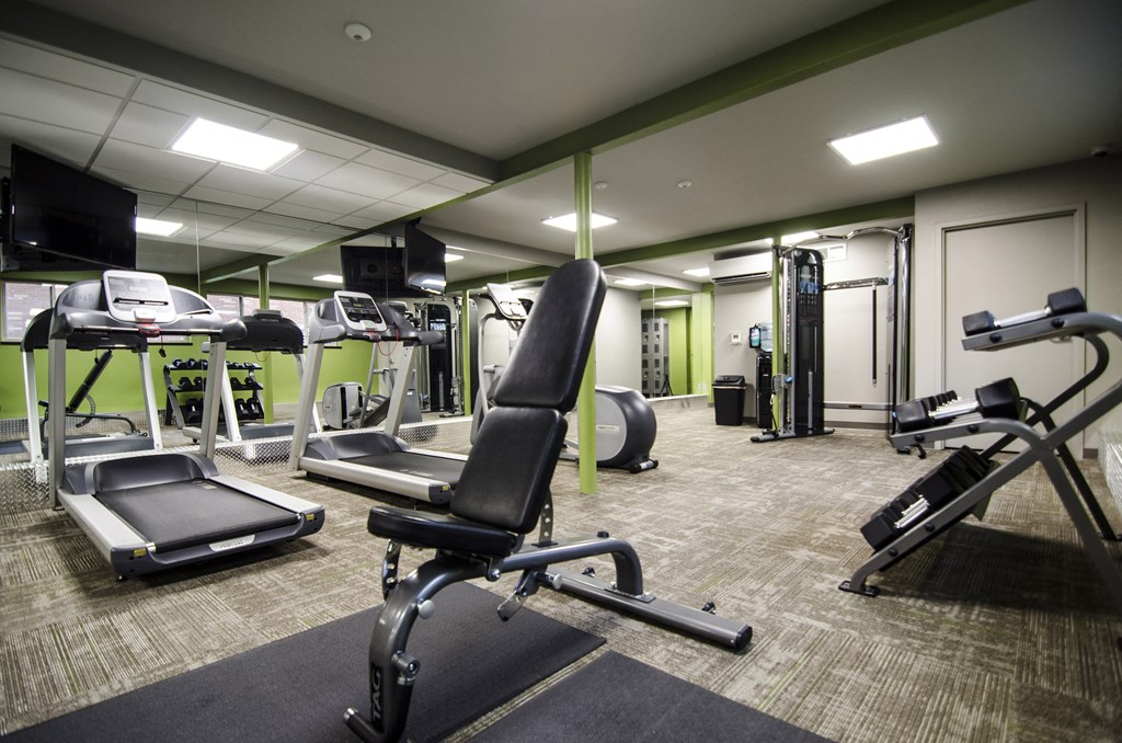a gym with treadmills and other exercise equipment in a building