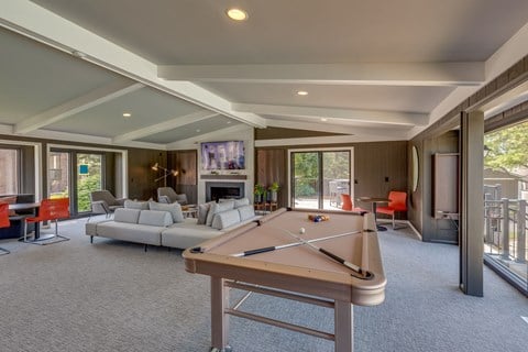 a large living room with a pool table