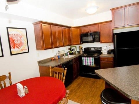 a kitchen with a red table