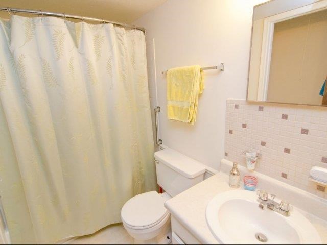 a bathroom with a toilet and a sink and a shower