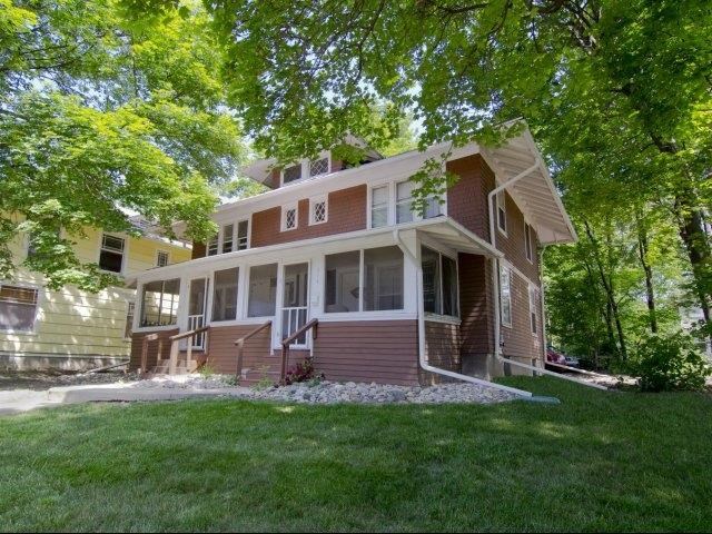 a brown and with a lawn and trees