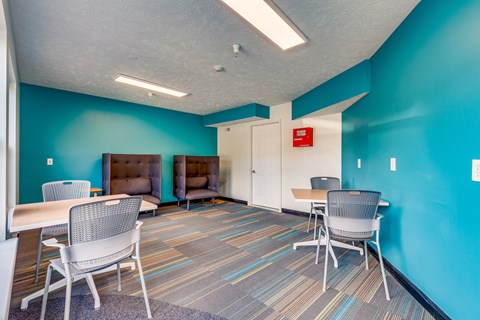 a meeting room with tables and chairs and a couch