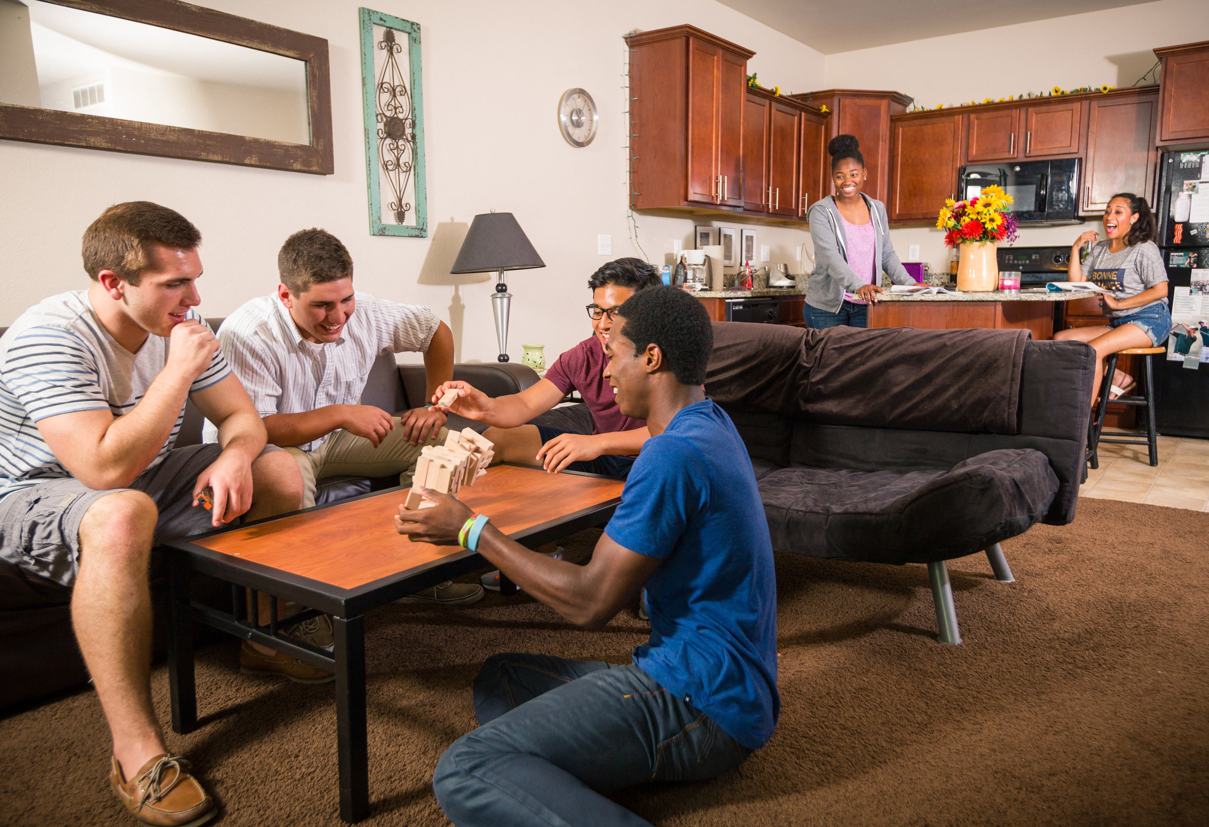 a group of people sitting in a living room playing a video game