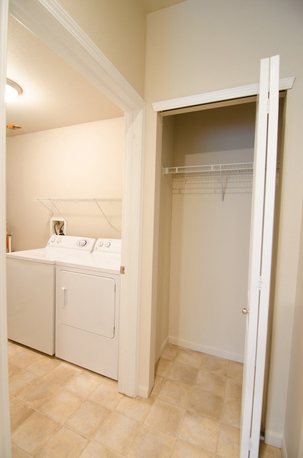 a laundry room with a washer and dryer and a closet