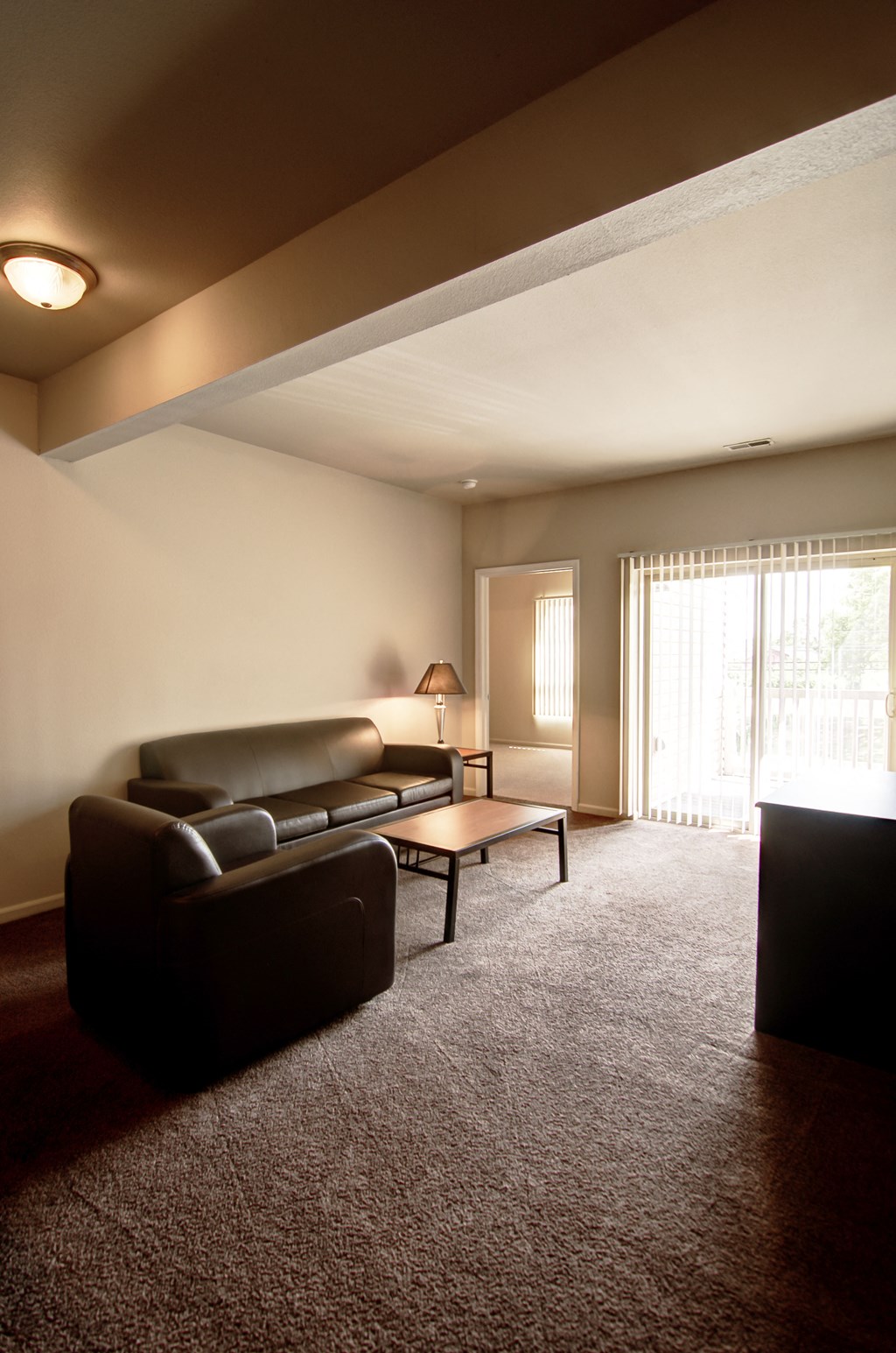 an empty living room with a couch and a table