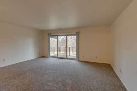 an empty living room with a sliding glass door