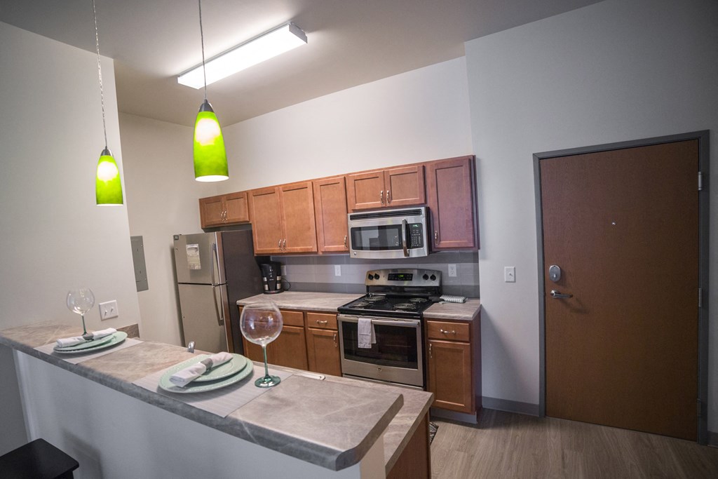 a kitchen with wooden cabinets and stainless steel appliances