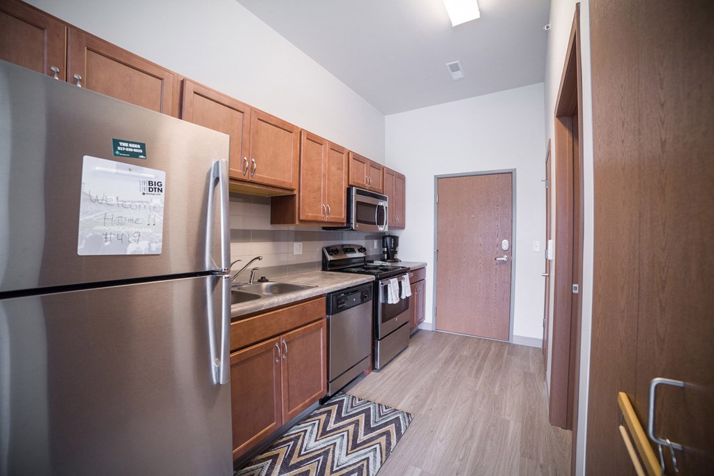 a kitchen with stainless steel appliances and wooden cabinets