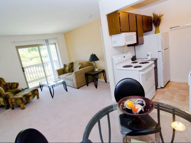 a living room with a kitchen and a table