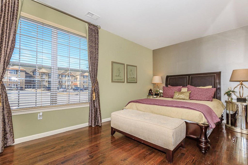 a bedroom with a bed and a large window