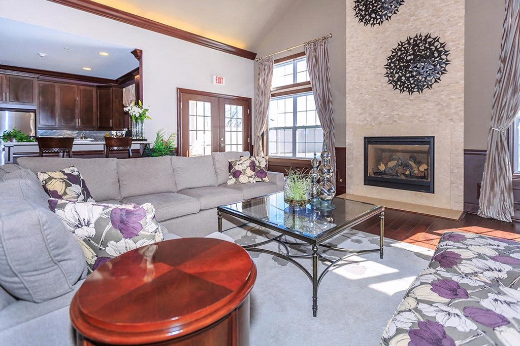a living room with a couch and a table and a fireplace