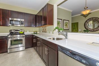 Designer Kitchens Featuring Shaker Style Wood Expresso Cabinets with Quartz Countertops