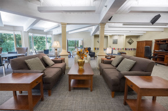 a large living room with couches and tables