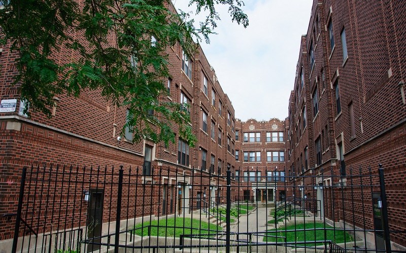 A courtyard surrounded by brick buildings.