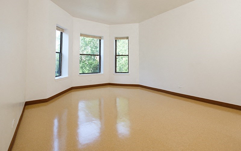 A room with a tan floor and white walls.