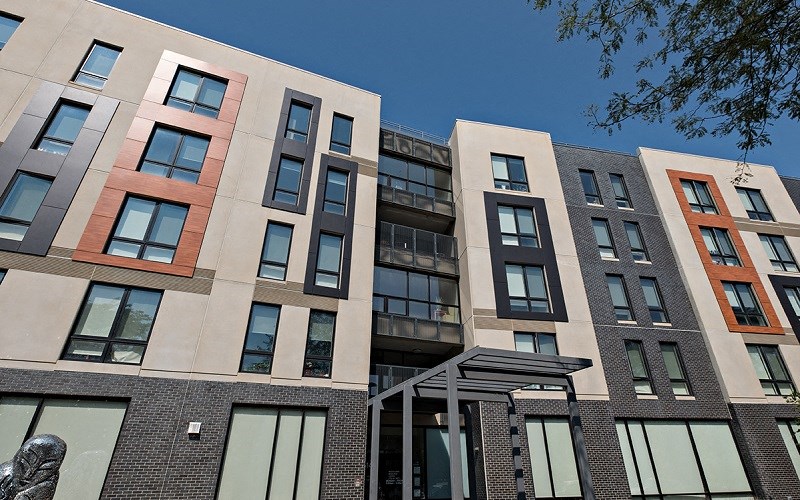 A modern building with a statue in front of it.