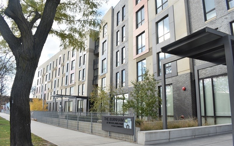 A modern apartment building named The Burnham is shown in the image.