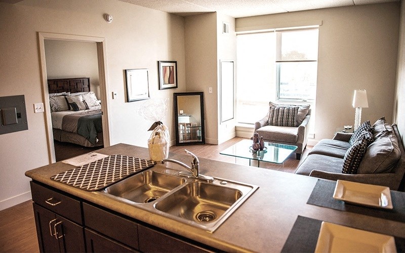 A kitchen with a sink and a counter top.