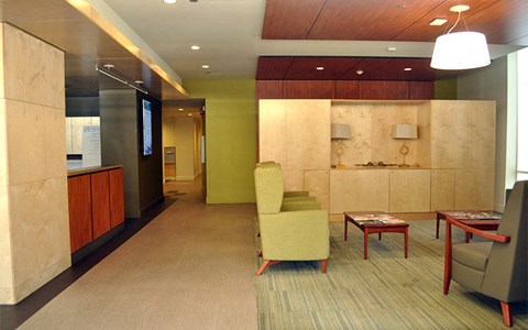 A conference room with a green chair and a table.