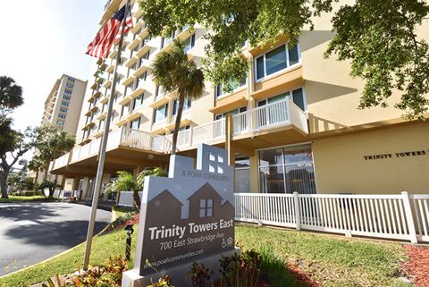 an image of the trinity towers east building with a sign in front of it
