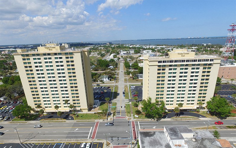 an aerial view of two tall buildings in a city