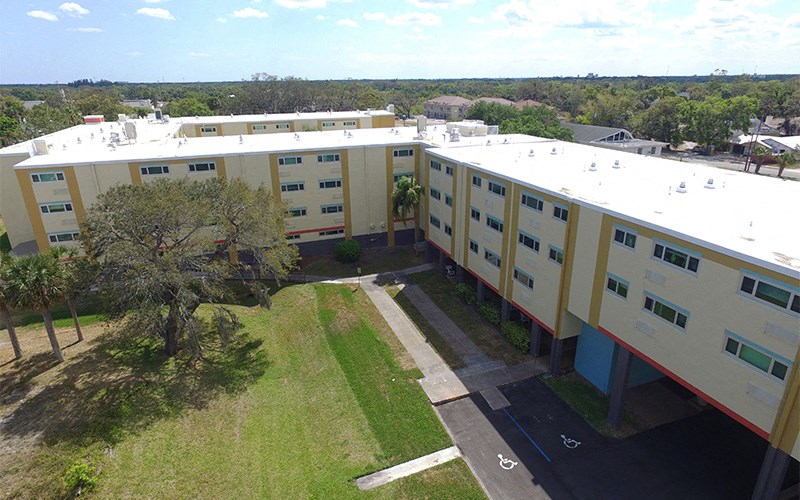 an aerial view of a large building with grass and trees