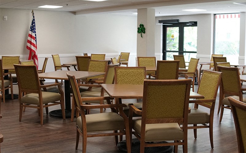 a dining room with tables and chairs and an flag