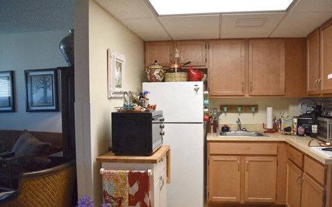 a kitchen with a white refrigerator and a microwave