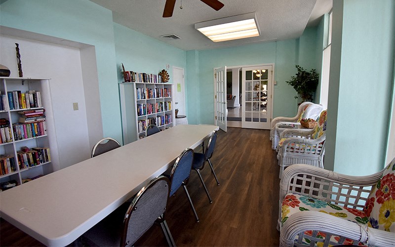 a dining room with a long table and chairs
