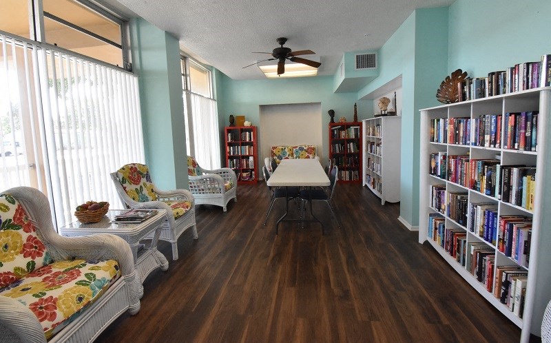 a dining room with a table and bookshelves