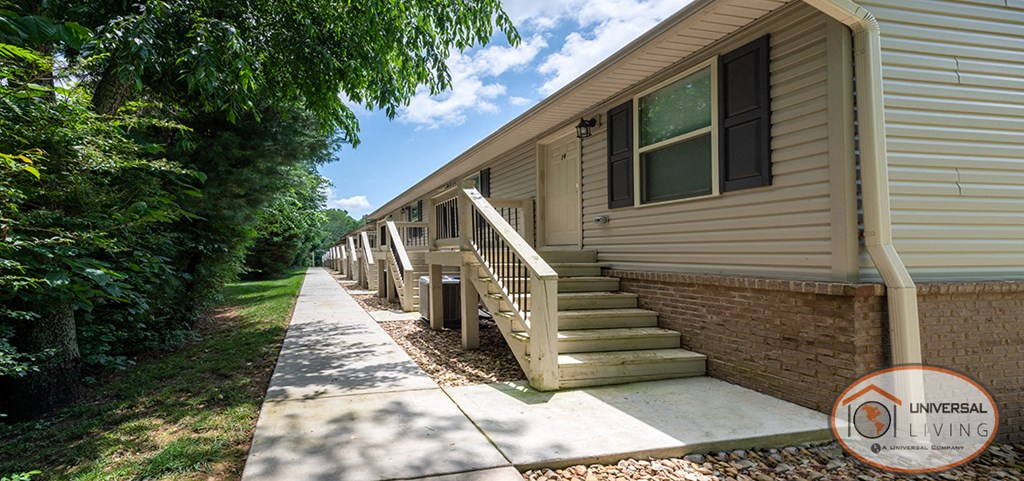 an exterior view of a house with stairs and a sidewalk