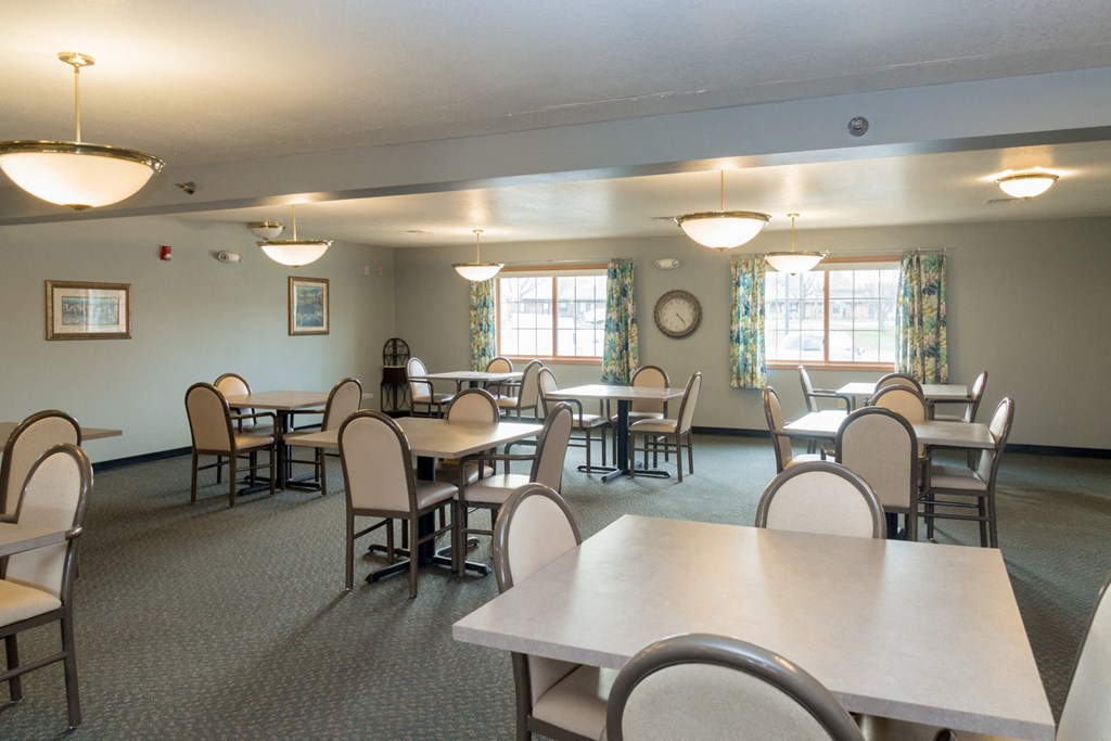 a multipurpose room with tables and chairs