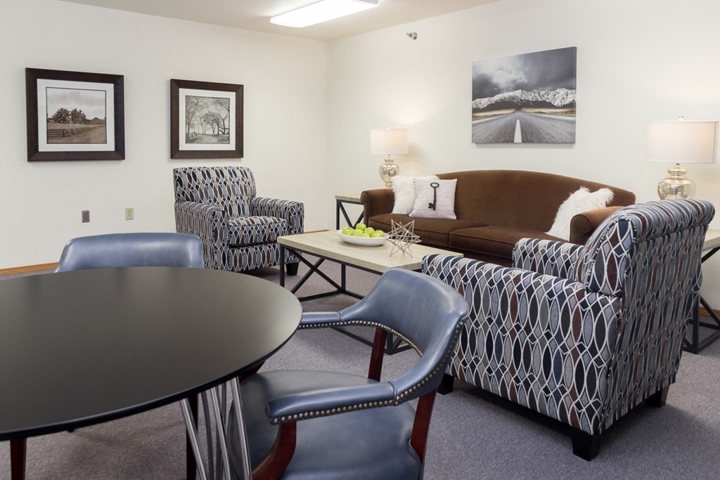 a living room with couches and chairs and a table