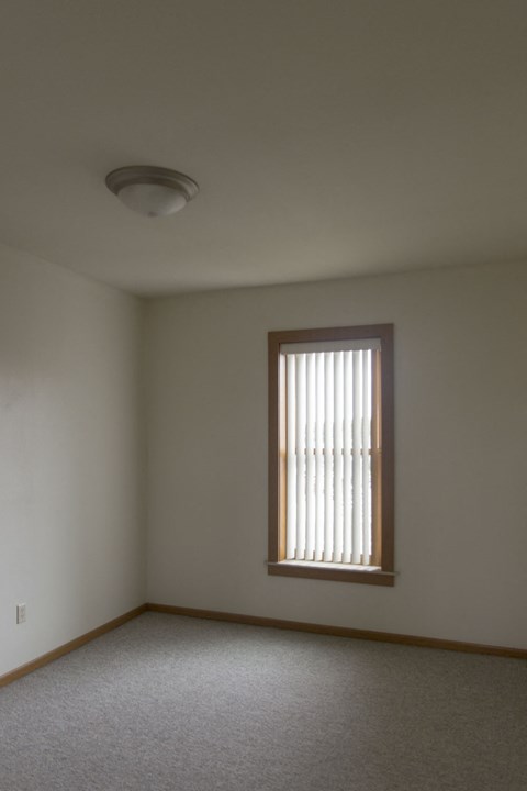 a living room with a window and a ceiling light